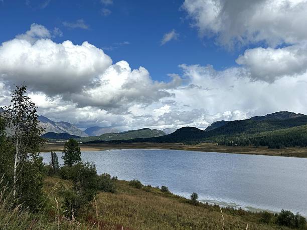 istock Tranquil water scene, Peaceful pond with trees and mountains 2253619401
