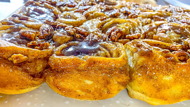 Freshly baked cinnamon rolls displayed after baking, showing a golden-brown finish and well-defined spiral layers. The image represents the final baking stage in a sweet food series, highlighting homemade baking, finished pastry, and ready-to-serve comfort food.