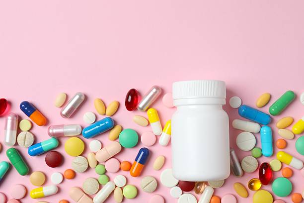 istock Various pills and medicine bottle on color background 2253620315