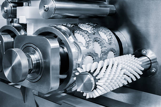 istock Candy and cake making machine with silver surface and bright light on it. The machine is used for cutting and molding food products 2253624350