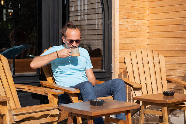 istock Relaxed Man Enjoying Coffee in Sunny Garden. 2253624703