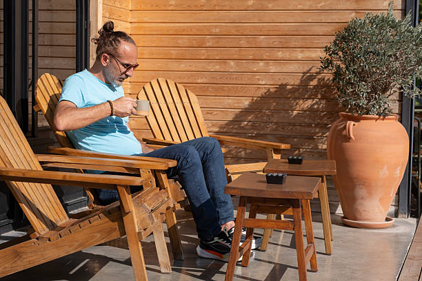 istock Relaxed Man Enjoying Coffee in Sunny Garden. 2253624738