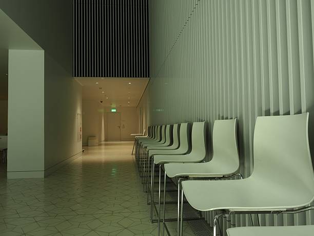 Chairs in the hall. Empty seats. Audience at the university. White plastic seats.