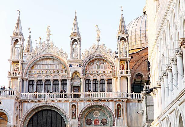 Venice, Italy - February 19, 2025: St. Mark's Basilica in Venice features ornate architecture with colorful mosaics and sculptures, highlighting its historical importance and beauty