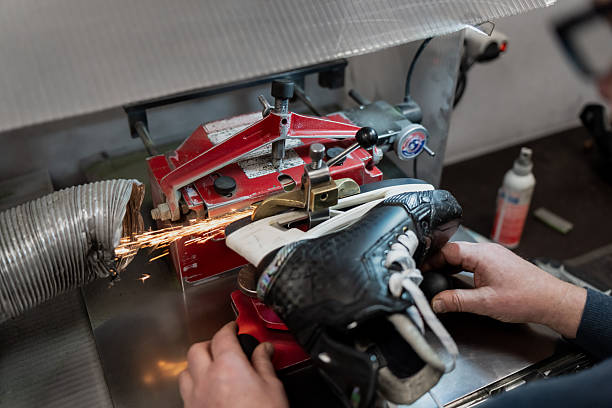 istock Professional hockey skate sharpening machine grinding blade with visible sparks during elite team equipment maintenance inside controlled sports service workshop 2253630913
