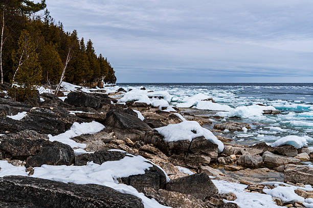istock Winter rocky shore with ice floes 2253632663