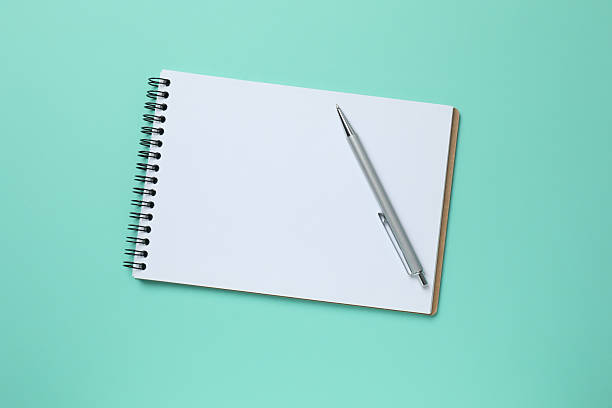 istock Flat lay with pen and notebook on color background, top view 2253633123