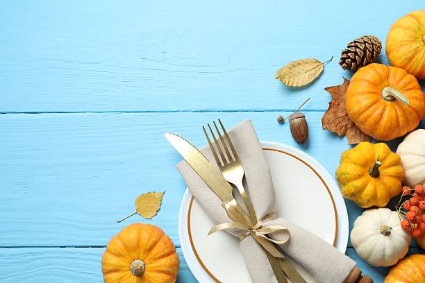 istock Rustic holiday table setup. Top view with plates, cutlery and autumn decorations. Empty space for your text 2253633738