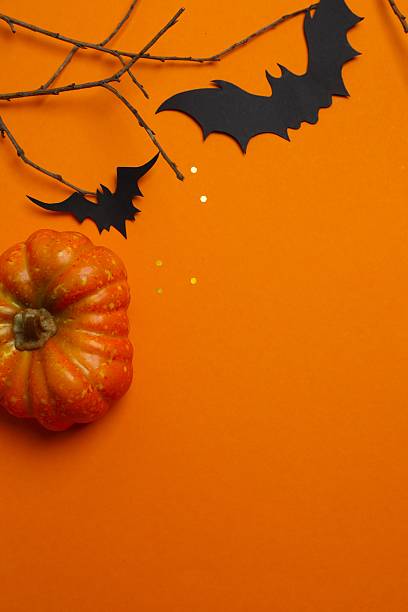istock Vertical Halloween festive background design featuring bats, pumpkin and decorative branches. Halloween concept 2253634627