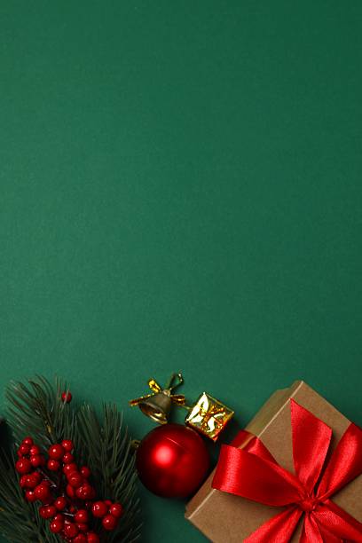 istock Vertical festive Christmas background with fir branches, gift box and different  decorations 2253635374