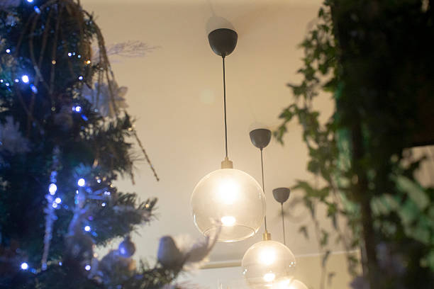 istock soft pendant lights around decorated holiday tree and plants 2253635437