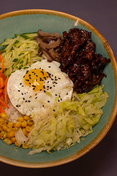 istock hearty rice bowl with beef, egg and shredded veggies, cozy meal 2253636468