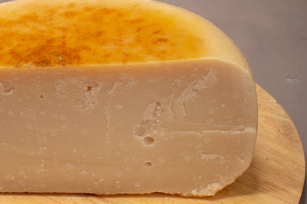 istock Photograph Displaying Textured Mature Cheese On Wooden Surface 2253637422