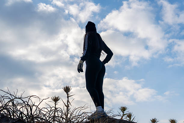 Woman standing on mountain exploring winter landscape