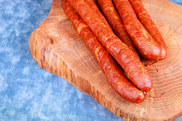 istock Sausages on wooden board ready for serving during meal preparation 2253639722