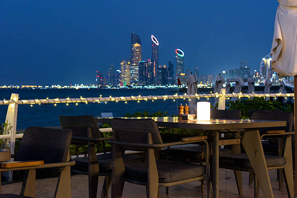istock Outdoor dining table overlooking Abu Dhabi Corniche skyline at night 2253640811
