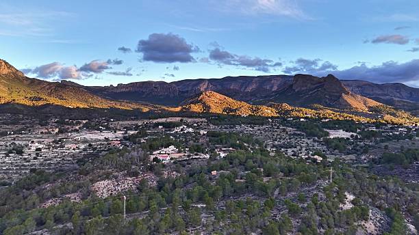 istock Peaceful valley with pine trees, Aerial view capturing serene sunset over mountain village landscape 2253640892