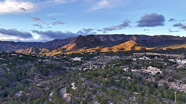 istock Sunlit mountain settlement with clouds, Drone shot capturing peaceful mountain community scenery 2253641379