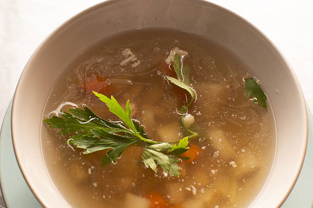 istock Warm herbal vegetable broth, Savory clear soup with carrots and herbs 2253641410