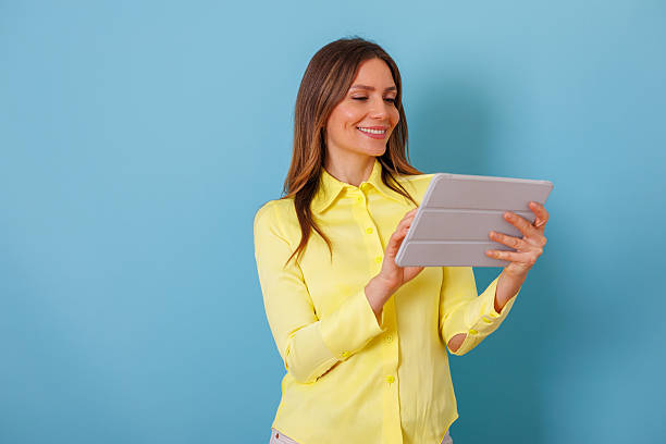 istock Woman enjoying online content on digital tablet, using new technology for communication and internet connection 2253641568