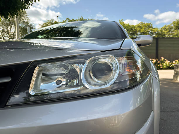 istock A shiny silver car headlight, meticulously designed, stands out against a bright blue sky, creating a visual contrast that captivates automotive enthusiasts and photographers with its beauty 2253641794