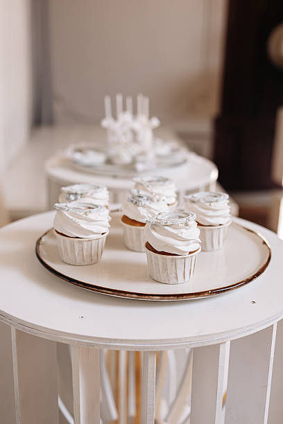 Indulge in Delightful Cupcakes Presented on Elegant White Stands, Perfect for Any Celebration or Gathering You Might Have, Adding a Touch of Charm and Sweetness to Your Special Moments