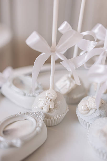 Delightful and Elegant White Cake Pops Decorated with Beautiful Ribbons, Perfectly Designed for a Baby Shower or Any Special Celebration Event, adding a touch of sweetness and charm