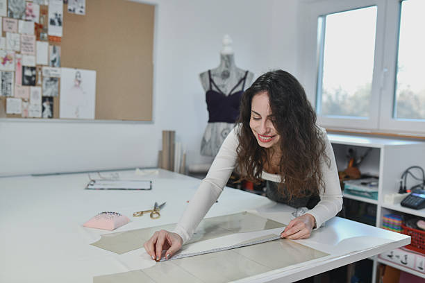 istock Designer Measuring, Marking, And Organizing Fabric For Dresses 2253644054