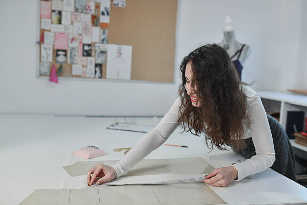 istock Designer Measuring, Marking, And Organizing Fabric For Dresses 2253644716