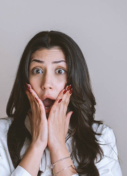Surprised young woman portrait, white background, Studio shot