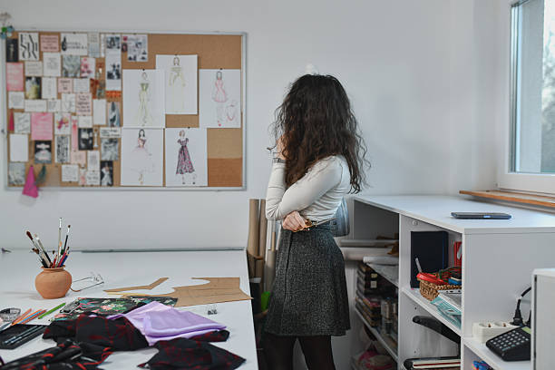 istock Confident Designer Looking at Hers Dress Sketches and Thinking 2253648512