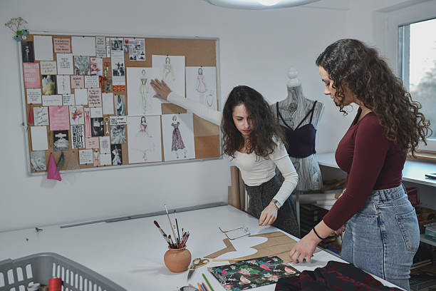 istock Fashion Designers Collaborate In Bright Studio With Dress Forms, Sketches, And Sewing Tools 2253648751