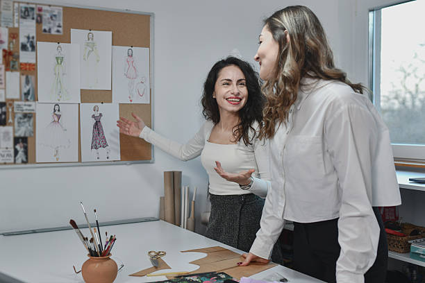 istock Bright Studio Scene Highlighting Worker Learning About Fashion Design 2253648802
