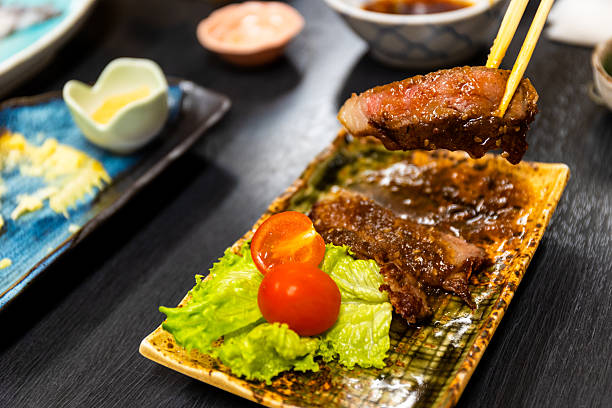 Picking up a slide of wagyu beef at a Japanese restaurant.