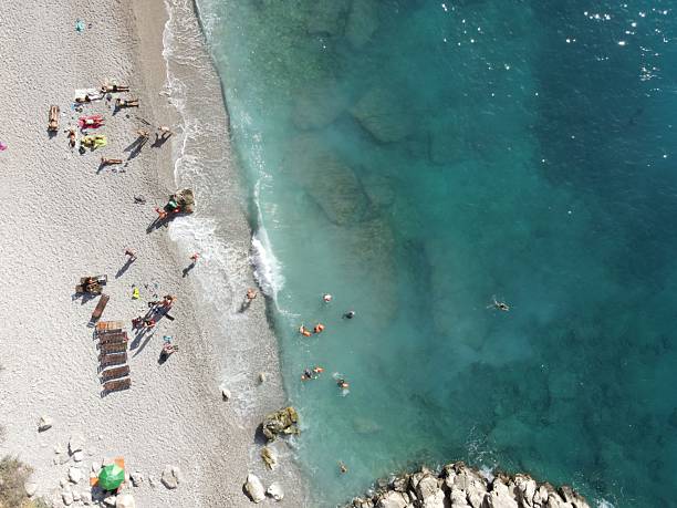 Aerial view of Butterfly Valley, also known as Kelebekler Vadisi, a protected natural canyon and beach with its crsytal clear turquoise waters on the Mediterranean coast near Ölüdeniz in Fethiye, Turkey.