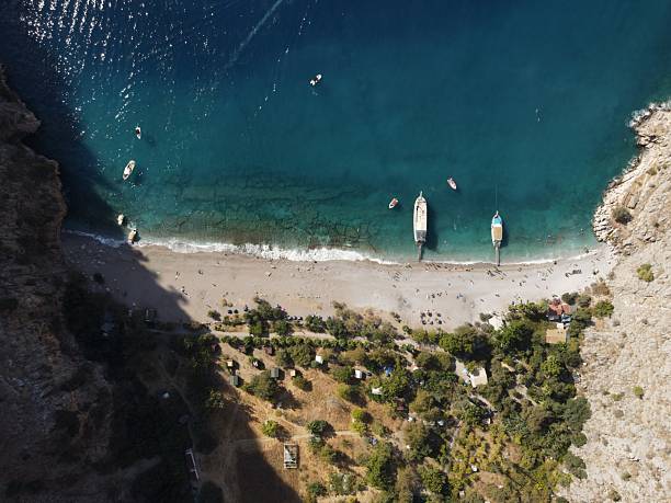 Aerial view of Butterfly Valley, also known as Kelebekler Vadisi, a protected natural canyon and beach with its crsytal clear turquoise waters on the Mediterranean coast near Ölüdeniz in Fethiye, Turkey.