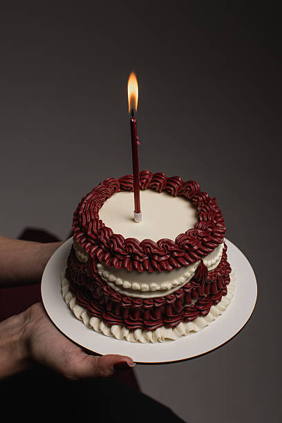 istock A wonderful and delightful celebratory twotier cake adorned with a lit candle, making it the perfect treat for birthdays and special occasions that call for a joyous celebration with loved ones 2253649683