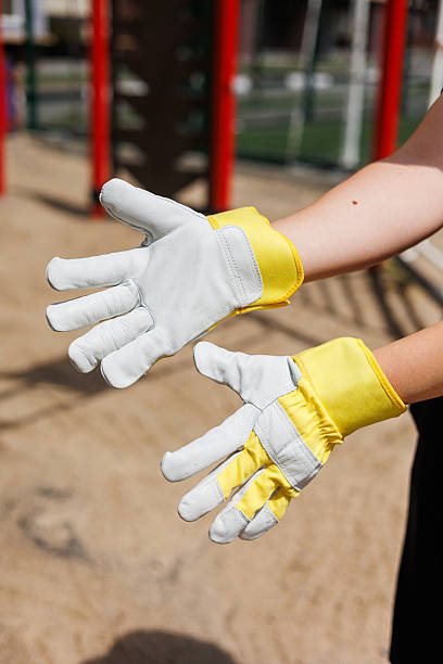 istock Discover highquality work gloves featuring vibrant yellow cuffs designed specifically to provide enhanced grip and superior protection during outdoor activities and landscaping projects of all kinds 2253653305