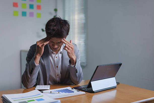 istock Businessman having headache struggling with work stress 2253655100