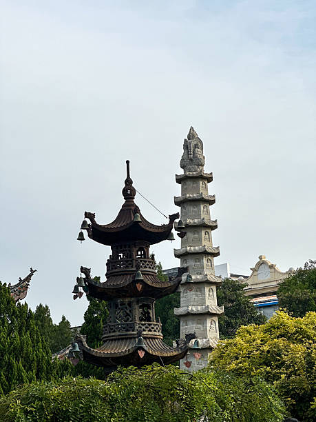 istock Stone Pagoda And Tower Rising Above Trees 2253658771