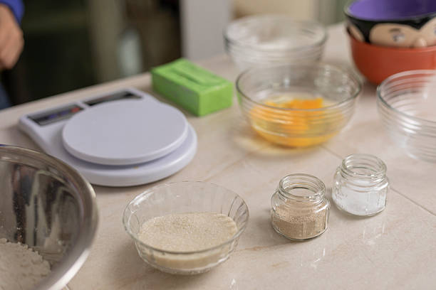 Preparing baking ingredients including flour, sugar, eggs, yeast, salt, and butter for making homemade pastries or bread