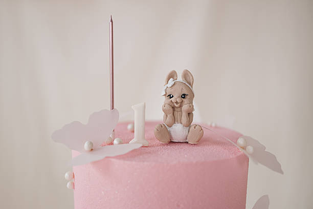 This delightful pink birthday cake with a charming bunny is the perfect centerpiece for a joyful first birthday celebration, ensuring a memorable experience for all guests at the party