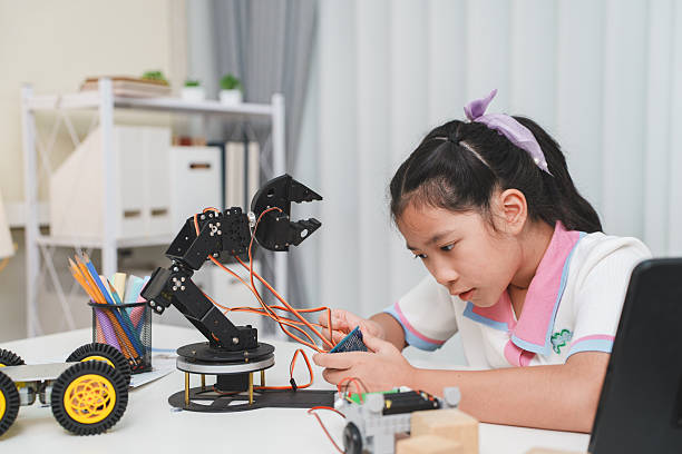 istock A young girl builds a robot, learning science and technology. STEM education concept. 2253662997