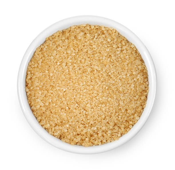 istock Brown sugar in bowl isolated on white, top view 2253663524