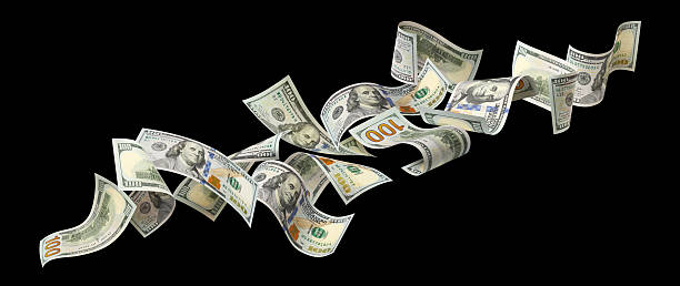 istock Flying hundred dollar bills, isolated on black background 2253663899