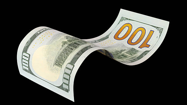 istock Curved hundred dollar banknote, isolated on black background 2253663906