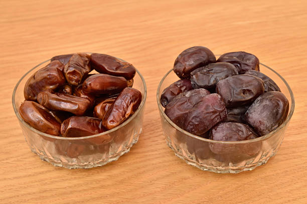 istock Dried and fresh dates in glass bowls 2253664678