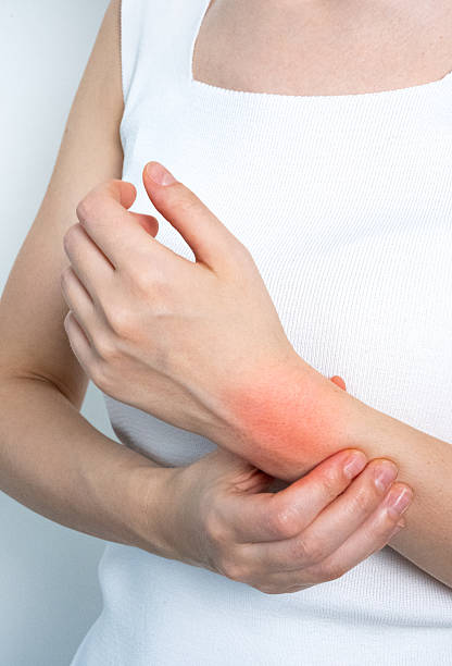 istock Woman holding arm with pain highlight concept 2253665632