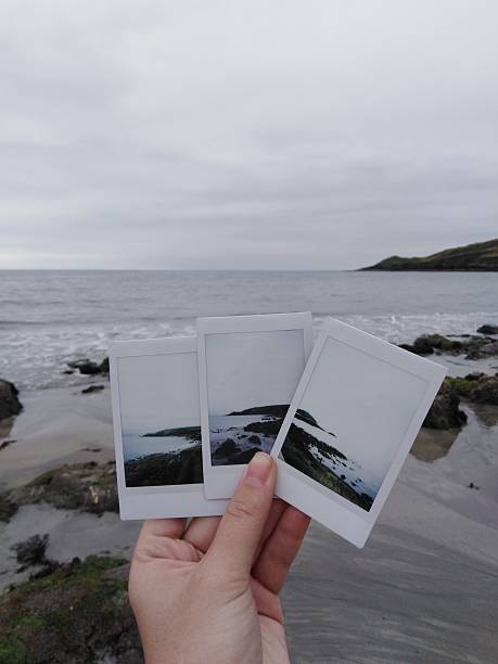 istock A Hand Holding Polaroids at the Ballycotton Beach 2253669025