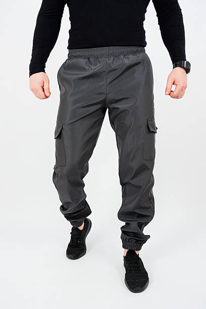 istock A man is dressed in a stylish black shirt paired with grey cargo pants 2253670706